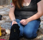 Woman Sitting Outside With a Black Standard Poodle
